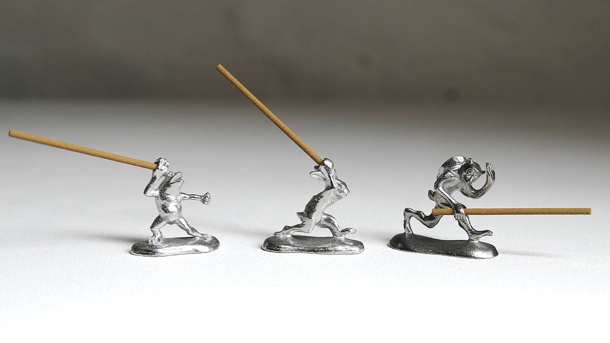 Three pewter incense holders inspired by Japan's Chōjū-giga scrolls, depicting a frog, rabbit and monkey holding incense sticks, by Sumitani Saburo Shoten.